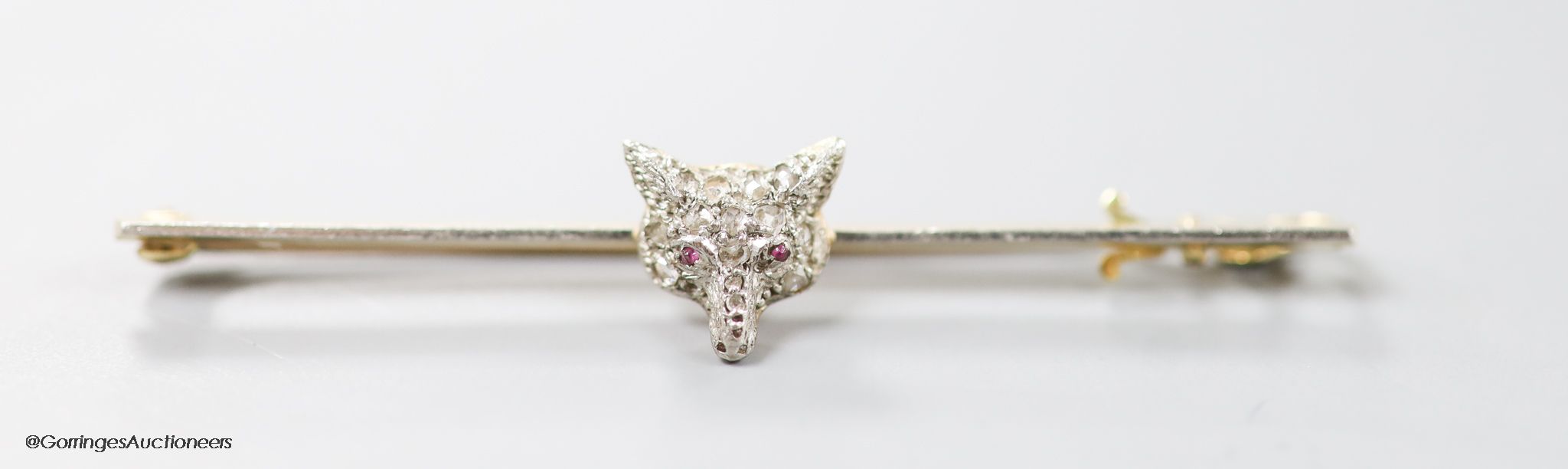 A late Victorian 15ct, pt and rose cut diamond set fox head bar brooch, 56mm, gross weight 3.4 grams.